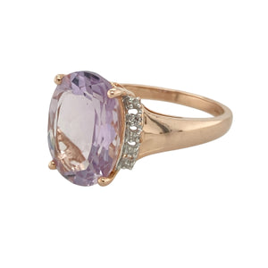 Introduce soft colour and bold elegance to your collection with this pre-owned 9ct rose gold diamond and lavender-purple stone ring—an eye-catching blend of gentle hues and refined sparkle.

Design: The centrepiece is a striking 14mm by 10mm oval-cut lavender-purple stone, offering a luminous and elegant presence. Diamonds are set into the shoulders, adding subtle brilliance and enhancing the ring's graceful lines.
