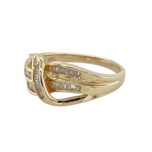 Add bold brilliance and sculptural elegance to your jewellery collection with this pre-owned 18ct yellow gold diamond wrap-over band ring—designed to stand out with style and sparkle.

Design: The ring features a split three-row wrap-over design, rising to 9mm at the front and set with baguette-cut diamonds that create a sleek, structured look.
Material: Made from 18-carat yellow gold, the rich finish enhances the clean lines and reflective facets of the baguette diamonds.
