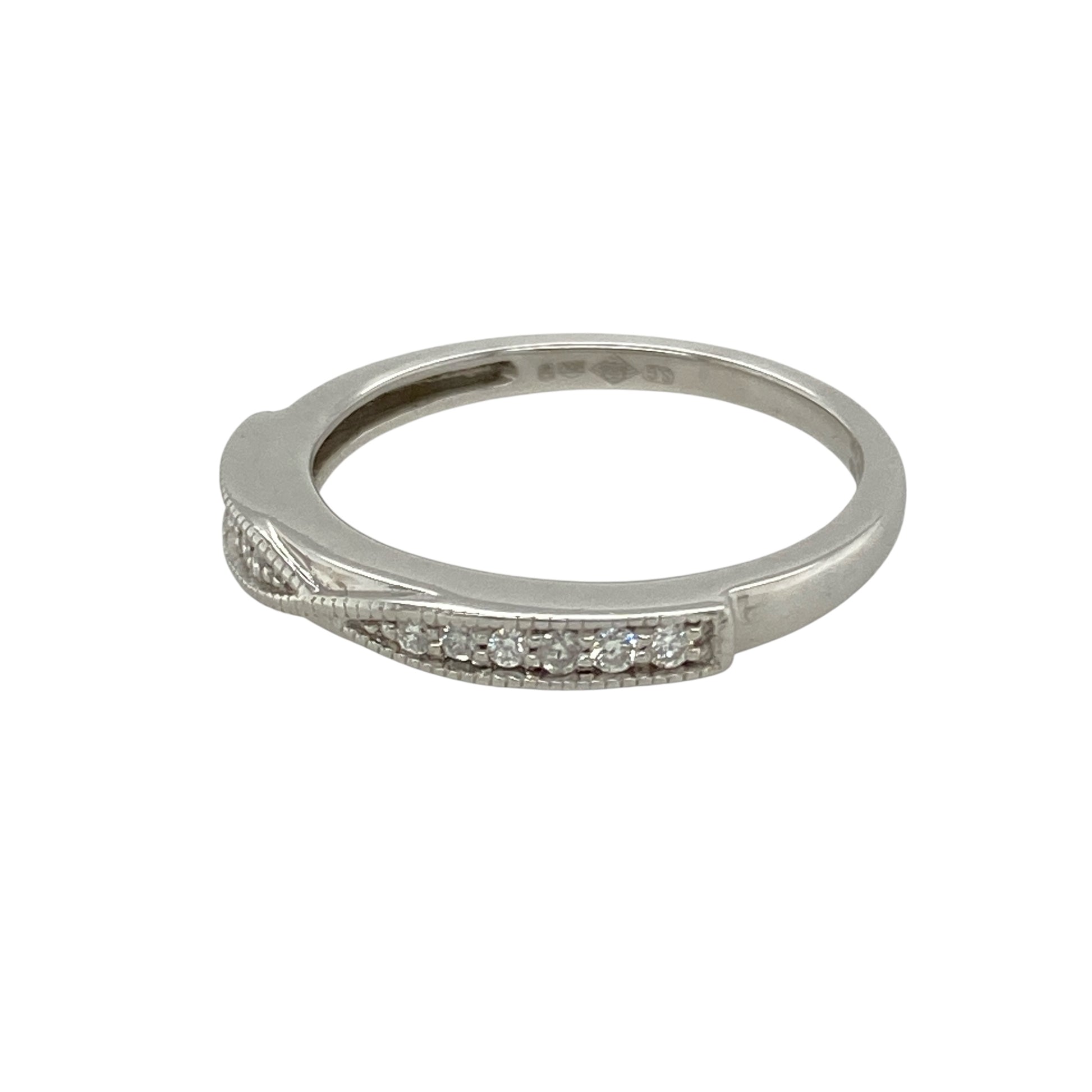 Add subtle sparkle and modern refinement to your jewellery collection with this pre-owned platinum diamond twist band ring—sleek, elegant, and perfect for everyday luxury.

Design: This ring features a delicate 2mm wide twist band, with diamonds seamlessly woven into the curve for a refined and fluid silhouette.
Material: Made from platinum, the cool-toned metal offers a bright, durable setting that enhances the brilliance of the diamonds.
