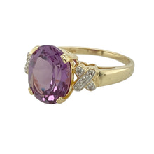 Load image into Gallery viewer, Add a touch of bold elegance and romantic detail to your collection with this pre-owned 9ct yellow gold diamond and amethyst ring—rich in colour, style, and sentiment.

Design: The ring features a striking 12mm by 10mm oval-cut amethyst at the centre, flanked by diamond-set &quot;X&quot; kiss-shaped accents on each shoulder in white gold for added contrast and sparkle.

