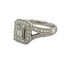 Load image into Gallery viewer, Add brilliant sparkle and timeless glamour to your collection with this pre-owned 9ct white gold diamond halo cluster ring—an elegant statement piece with layered detail and dazzling presence.

Design: The 10mm high front features a striking cluster centre made up of brilliant and baguette-cut diamonds, surrounded by a halo of brilliant-cut diamonds for added radiance. Additional diamonds are set along the shoulders, completing the luxurious design.

