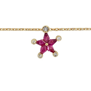 Bring celestial charm and rich colour to your collection with this pre-owned 18ct yellow gold diamond and ruby star pendant necklace—a radiant piece full of sparkle and symbolism.

Design: The 1.2cm long star-shaped pendant features five vibrant ruby stones, with a brilliant diamond set at the tip of each star point for added brilliance and definition.
Material: Made from 18-carat yellow gold, the warm setting enhances the deep red of the rubies