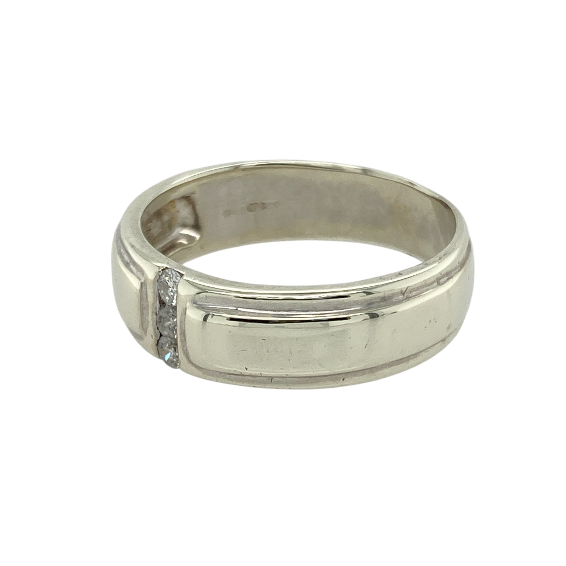 Add modern elegance and subtle sparkle to your collection with this pre-owned 9ct white gold diamond set band ring—a refined design with a sleek, contemporary edge.

Design: This 6mm wide band features three small diamonds set in a vertical line down the centre of the ring, creating a clean, balanced look with understated brilliance.
Material: Made from 9-carat white gold, the cool, polished finish enhances the modern styling and provides a sophisticated backdrop for the diamond accents.
