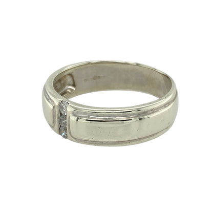 Add modern elegance and subtle sparkle to your collection with this pre-owned 9ct white gold diamond set band ring—a refined design with a sleek, contemporary edge.

Design: This 6mm wide band features three small diamonds set in a vertical line down the centre of the ring, creating a clean, balanced look with understated brilliance.
Material: Made from 9-carat white gold, the cool, polished finish enhances the modern styling and provides a sophisticated backdrop for the diamond accents.
