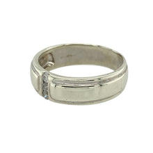 Load image into Gallery viewer, Add modern elegance and subtle sparkle to your collection with this pre-owned 9ct white gold diamond set band ring—a refined design with a sleek, contemporary edge.

Design: This 6mm wide band features three small diamonds set in a vertical line down the centre of the ring, creating a clean, balanced look with understated brilliance.
Material: Made from 9-carat white gold, the cool, polished finish enhances the modern styling and provides a sophisticated backdrop for the diamond accents.


