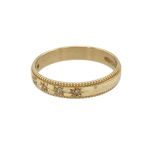 Add vintage charm and delicate sparkle to your jewellery collection with this pre-owned 9ct yellow gold diamond set milgrain edge band ring—elegant, timeless, and full of detail.

Design: This 3mm wide band features six small diamonds set in starburst-style engravings across the band, accented by fine milgrain edging for a refined, antique-inspired finish.
Material: Made from 9-carat yellow gold, the warm, polished tone enhances the intricate design and highlights the subtle brilliance of each diamond.
