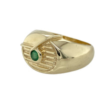Load image into Gallery viewer, Make a bold and elegant statement with this pre-owned 9ct yellow gold emerald set oval signet ring—rich in style, heritage, and colour.

Design: The ring features a 14mm high oval face with a central round emerald approximately 3.5mm in diameter, set against a striped-style patterned background for added depth and texture.
Material: Made from 9-carat yellow gold, the polished finish enhances the bold design while complementing the vibrant green hue of the emerald.

