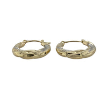 Load image into Gallery viewer, Add elegant movement and contrast to your look with these pre-owned 9ct yellow and white gold patterned twisted hoop creole earrings—timeless with a modern twist.

Design: These creole-style hoops feature a twisted design combining both yellow and white gold, enhanced with fine patterning for added texture and shine.
Material: Made from 9-carat yellow and white gold, the two-tone finish creates a beautiful contrast, offering versatility and refined style.


