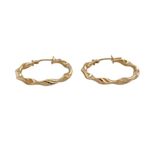 Load image into Gallery viewer, Add classic texture and golden shine to your everyday style with these pre-owned 9ct yellow gold twisted hoop creole earrings—timeless, lightweight, and effortlessly elegant.

Design: These hoop earrings feature a gently twisted design, giving a dynamic look with added depth and movement in a traditional creole shape.
Material: Made from 9-carat yellow gold, the polished finish highlights the twist pattern and adds a warm, radiant glow.

