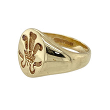 Load image into Gallery viewer, Celebrate heritage with timeless style in this pre-owned 9ct yellow gold Welsh Three Feathers oval signet ring—rich in symbolism and classic in design.

Design: The ring features a 12mm high oval face engraved with the iconic Welsh Three Feathers emblem, offering a proud tribute to tradition with a refined look.
Material: Made from 9-carat yellow gold, the polished finish adds warmth and shine, enhancing the detailed engraving and traditional silhouette.

