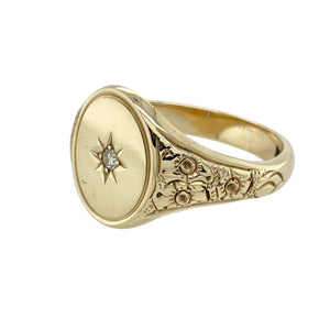 Make a bold and distinguished statement with this pre-owned 9ct yellow gold diamond set oval signet ring—refined design with classic heritage appeal.

Design: The ring features a 15mm high oval face with a single diamond accent, framed by detailed patterned shoulders that add texture and sophistication.
Material: Made from 9-carat yellow gold, the polished finish enhances the engraving and complements the subtle sparkle of the diamond.
