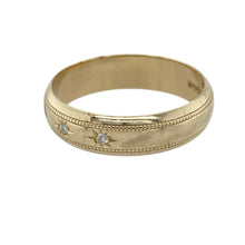 Load image into Gallery viewer, Add vintage charm and subtle sparkle to your collection with this pre-owned 9ct yellow gold diamond set band ring—classic detail with timeless elegance.

Design: This band features a refined milgrain edge and three small diamonds set in starburst-style engravings, blending texture and sparkle with a vintage-inspired finish.
Material: Made from 9-carat yellow gold, the polished surface enhances the intricate detailing and adds a warm, radiant glow.

