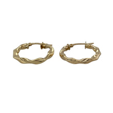 Load image into Gallery viewer, Add graceful movement and subtle texture to your look with these pre-owned 9ct yellow gold twisted ribbon hoop creole earrings—elegant, lightweight, and effortlessly chic.

Design: These creole-style hoops feature a twisted ribbon design, creating gentle curves and soft dimension for a fluid, feminine silhouette.
Material: Made from 9-carat yellow gold, the polished finish enhances the flowing design and provides a warm, radiant shine.

