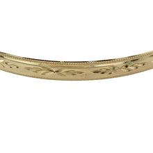 Load image into Gallery viewer, Add timeless elegance and refined detail to your collection with this pre-owned 9ct yellow solid gold patterned bangle—classic design with a bold, polished presence.

Design: This bangle features a 5mm wide band with intricate engraved patterning, offering a touch of texture and traditional charm in a sleek, rounded silhouette.
Material: Made from solid 9-carat yellow gold, the polished finish enhances the decorative detailing and provides a rich, radiant glow.

