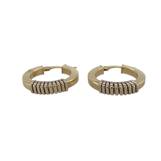 Add contrast and sophistication to your collection with these pre-owned 9ct yellow gold hoop creole earrings featuring white gold wrap-around detail—bold, elegant, and timelessly stylish.

Design: These creole-style hoops showcase a classic yellow gold base accented with a sleek white gold wrap-around detail, creating a refined two-tone look with added dimension.
Material: Crafted from 9-carat yellow and white gold, the polished finish enhances the colour contrast and adds a radiant, luxurious glow.
