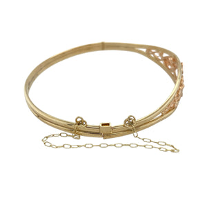 Celebrate heritage and elegance with this pre-owned 9ct yellow and rose gold Clogau Tree of Life bangle—rich in meaning, beautifully detailed, and timeless in design.

Design: The front of the bangle features the iconic Tree of Life motif in a flowing design that symbolises growth, strength, and connection. The front section is 12mm high, offering a bold and graceful presence.
