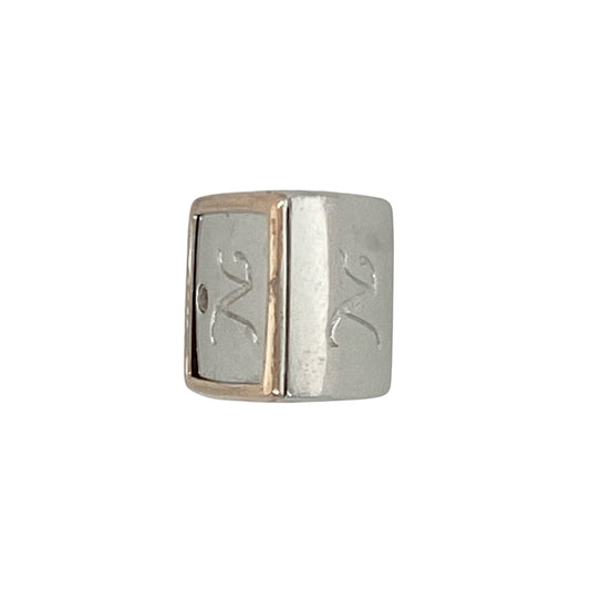 Add a personal touch of sparkle and heritage to your collection with this pre-owned 925 silver, 9ct rose gold, and diamond set Clogau 'N' initial charm—elegant, meaningful, and beautifully crafted.

Design: This stylish charm features the letter N in polished sterling silver, accented with a band of rare 9ct Welsh rose gold and a sparkling diamond for a refined, personalised finish.
Material: Made from 925 sterling silver with 9-carat rose gold and diamond detail