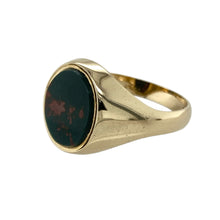 Load image into Gallery viewer, Add classic distinction and deep colour to your collection with this pre-owned 9ct yellow gold and bloodstone oval signet ring—refined, traditional, and full of character.

Design: This timeless signet ring features a 12mm by 10mm oval bloodstone, known for its rich green hue with natural red flecks, set in a polished gold bezel for a bold, elegant look.
Material: Made from 9-carat yellow gold, the smooth finish enhances the depth of the bloodstone and offers a warm, luxurious glow.

