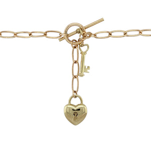 Add romantic charm and vintage style to your collection with this pre-owned 9ct yellow and rose gold open link curb chain—elegant, meaningful, and beautifully detailed.

Design: This 18" chain features alternating open curb links with a 4mm width, finished with a classic heart-shaped padlock and matching key for a timeless touch of romance.
Material: Crafted from 9-carat yellow and rose gold, the polished finish highlights the soft contrast between the metals and adds a warm, glowing appeal.
