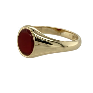 Bring timeless elegance and warm, earthy tones to your collection with this pre-owned 9ct yellow gold and carnelian oval signet ring—blending classic design with understated charm for everyday style or thoughtful gifting.

Design: The ring features a smooth 9mm by 7mm oval carnelian, with its rich reddish-brown hue offering a subtle yet distinctive focal point in a traditional signet style.
