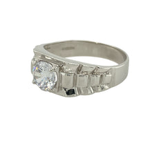 Load image into Gallery viewer, Add bold design and modern sparkle to your collection with this pre-owned 9ct white gold cubic zirconia set watch strap style ring—striking, unique, and full of contemporary flair.

Design: The ring features a watch strap-inspired design with a 7mm diameter central cubic zirconia stone, creating a bold and eye-catching focal point.
Material: Made from 9-carat white gold, the polished finish enhances the modern styling and the brilliance of the central stone.

