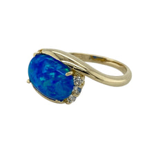 Load image into Gallery viewer, Add graceful shimmer and elegant detail to your collection with this pre-owned 14ct yellow gold opalique and cubic zirconia set twist ring—feminine, eye-catching, and perfect for refined styling.

Design: The ring features a 12mm by 8mm oval opalique stone at the centre, accented by a sparkling twist of cubic zirconia that wraps elegantly around the setting.

