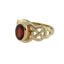 Load image into Gallery viewer, Add rich colour and meaningful design to your collection with this pre-owned 9ct yellow and rose gold garnet set Clogau Celtic knot ring—elegant, symbolic, and full of heritage charm.

Design: The ring features a 7mm by 5mm oval garnet at the centre, framed by intricate Celtic knot detailing on the shoulders, symbolising eternity and connection.
Material: Made from 9-carat yellow and rose gold, the polished finish enhances the warmth of the metals and the deep red glow of the garnet.

