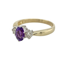 Load image into Gallery viewer, Bring rich colour and classic sparkle to your collection with this pre-owned 9ct yellow gold trilogy ring, featuring a vibrant amethyst flanked by diamonds—perfect for meaningful moments or timeless everyday elegance.

Design: The ring showcases a 7mm by 5mm oval-cut amethyst at the centre, with a brilliant-cut diamond on either side. The trilogy arrangement symbolises past, present, and future, adding sentimental value to its elegant style.

