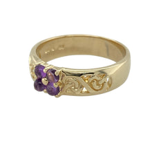 Load image into Gallery viewer, Bring symbolic beauty and rich colour to your collection with this pre-owned 9ct yellow gold Celtic knot ring, featuring deep purple amethysts in an intricate design—perfect for those who appreciate heritage style with meaningful detail.

Design: The ring features four small round amethyst stones set at the centre of an ornate Celtic knot band. The interwoven pattern symbolises eternity and unity, while the rich purple stones add a regal touch.

