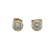 Load image into Gallery viewer, Bring refined sparkle and everyday elegance to your collection with these pre-owned 9ct yellow gold stud earrings, featuring rubover-set cubic zirconia—perfect for versatile wear with a polished finish.

Design: Each earring features a 4mm round cubic zirconia stone securely held in a smooth rubover setting, offering a clean and modern look with a subtle sparkle.
Material: Made from 9-carat yellow gold, the polished finish complements the brilliance of the stones while adding warmth and timeless appeal.

