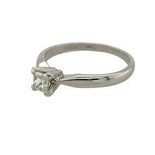 Load image into Gallery viewer, Bring refined elegance and timeless sparkle to your collection with this pre-owned 18ct white gold solitaire ring, featuring a princess cut diamond in a sleek setting—perfect for sophisticated proposals or everyday luxury.

Design: The ring features a single princess cut diamond of approximately 0.26ct, held in a clean and modern solitaire setting. The diamond has an approximate clarity of VS2 and a colour grade between J and K, offering bright sparkle with excellent clarity.

