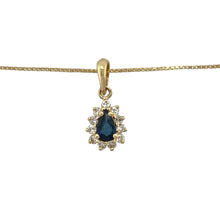 Load image into Gallery viewer, Bring rich colour and timeless sparkle to your collection with this pre-owned 18ct yellow gold teardrop cluster pendant necklace, featuring a vivid sapphire surrounded by diamonds—perfect for elegant occasions or refined everyday wear.

Design: The pendant measures 1.6cm long including the bail and showcases a central 5mm by 3mm oval-cut sapphire, framed by a delicate cluster of brilliant-cut diamonds in a classic teardrop shape. It hangs from an 18&quot; yellow gold box chain for a graceful finish.

