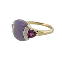 Load image into Gallery viewer, Bring bold colour and distinctive elegance to your collection with this pre-owned 9ct yellow and white gold dress ring, featuring a smooth purple jade-like centre stone accented with diamonds and rich purple tourmaline-coloured side stones—perfect for making a refined statement.

Design: The ring features a central smooth, opaque purple jade-like stone measuring 12mm by 9mm, flanked by two faceted purple tourmaline-coloured stones, each approximately 5mm by 5mm by 5mm.
