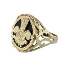 Load image into Gallery viewer, Make a statement with bold design and symbolic detail in this pre-owned 9ct yellow gold black stone backed three feather signet ring—perfect for standout style with historic inspiration.

Design: The ring features a striking 19mm high front with a polished black stone background, showcasing a detailed three feather emblem for a bold and meaningful look.
Material: Made from 9-carat yellow gold, the polished finish adds warmth and contrast to the deep tone of the stone.

