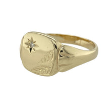Load image into Gallery viewer, Add vintage flair and a hint of sparkle to your collection with this pre-owned 9ct yellow gold and diamond starburst signet ring—perfect for bold style with classic detailing.

Design: The ring features a 12mm high front with a central diamond set in a starburst pattern, framed by finely patterned corners for added depth and character.
Material: Made from 9-carat yellow gold, the polished finish enhances the warm tone of the metal and the brilliance of the diamond accent.

