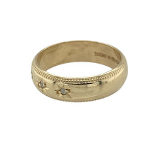Load image into Gallery viewer, Add subtle sparkle and vintage-inspired detail to your collection with this pre-owned 9ct yellow gold diamond set band ring—perfect for everyday elegance with classic charm.

Design: The 5mm wide band features three small diamonds set in starburst settings across the front, framed by delicate milgrain edging for a refined, traditional look.
Material: Made from 9-carat yellow gold, the polished finish enhances the warm tone of the band and highlights the fine detailing.

