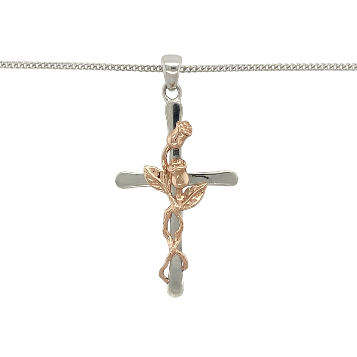 Add symbolic beauty and delicate detail to your collection with this pre-owned Clogau rose vine cross pendant on an 18" curb chain—perfect for meaningful style with elegant contrast.

Design: The pendant measures 4cm long including the bail and features a flowing cross design crafted in sterling silver, adorned with a 9ct rose gold rose and vine motif for a touch of romantic symbolism.
