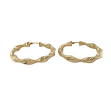 Load image into Gallery viewer, Add sculptural style and radiant shine to your collection with these pre-owned 9ct yellow gold hoop ribbon twisted creole earrings—perfect for standout elegance with a modern twist.

Design: Each earring features a flowing ribbon-inspired twist in a classic creole hoop shape, creating movement and dimension for a bold yet refined look.
Material: Made from 9-carat yellow gold, the polished finish highlights the curves and texture with a warm, luminous glow.

