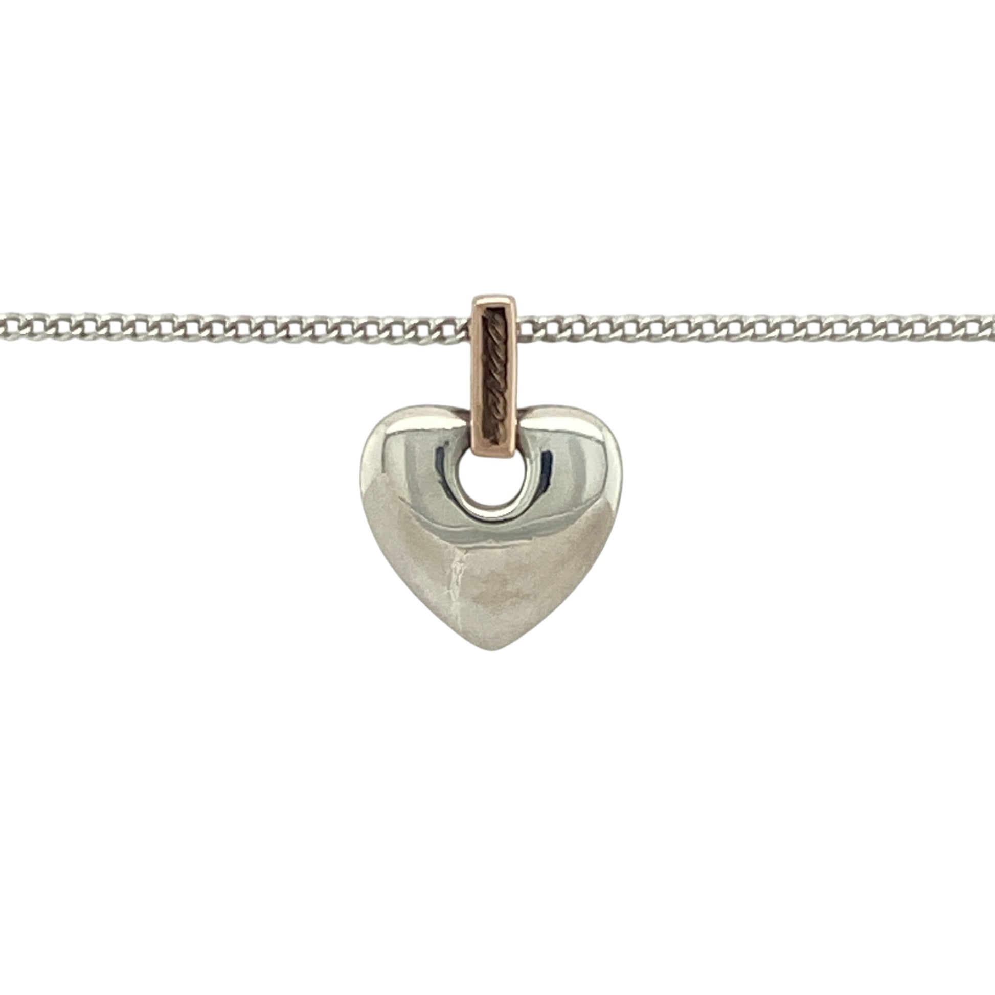 Bring heartfelt sentiment and Welsh heritage to your jewellery collection with this pre-owned Clogau heart pendant—crafted in 925 silver with 9ct Clogau rose gold on an adjustable curb chain for a meaningful and elegant finish.

Design: The 1.5cm long heart pendant, including the bail, features the Welsh word Cariad—meaning ‘love’—engraved on the bail, blending emotion with timeless design.
