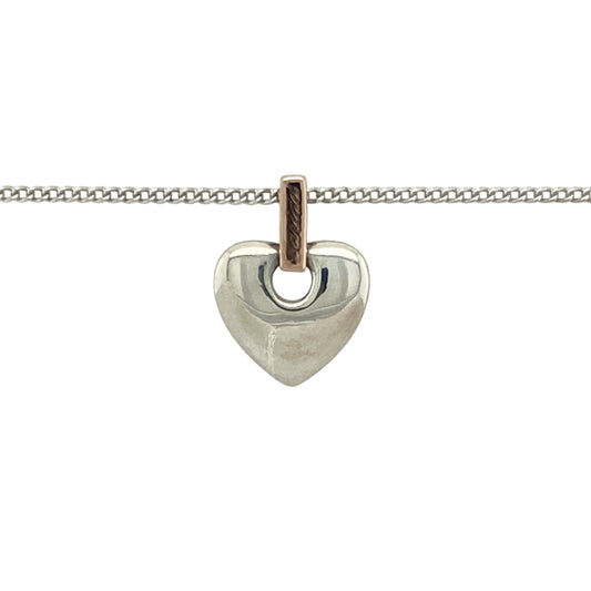 Bring heartfelt sentiment and Welsh heritage to your jewellery collection with this pre-owned Clogau heart pendant—crafted in 925 silver with 9ct Clogau rose gold on an adjustable curb chain for a meaningful and elegant finish.

Design: The 1.5cm long heart pendant, including the bail, features the Welsh word Cariad—meaning ‘love’—engraved on the bail, blending emotion with timeless design.
