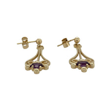 Load image into Gallery viewer, Bring rich colour and elegant movement to your jewellery collection with these pre-owned 9ct yellow gold amethyst fancy drop earrings—a graceful pair with vintage charm and refined detail.

Design: Each earring features a 7mm by 4mm amethyst stone in a decorative drop setting, adding a touch of classic sophistication and vibrant purple hue.
Material: Made from 9-carat yellow gold, the polished finish complements the depth of the amethysts with a warm, elegant glow.

