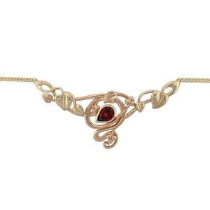 Bring rich colour and symbolic elegance to your jewellery collection with this pre-owned 9ct yellow and rose gold garnet Clogau Tree of Life necklace—a meaningful piece combining natural beauty with heritage design.

Design: The 16.5" necklace features a detailed Tree of Life motif crafted in yellow and rose gold, highlighted by a 7mm by 5mm teardrop-shaped red garnet that adds depth and vibrant colour.
