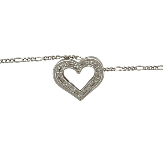 Bring delicate sparkle and heartfelt elegance to your jewellery collection with this pre-owned 9ct white gold diamond open heart pendant on an 18" Figaro chain—a timeless piece with graceful charm and romantic detail.

Design: The 10mm by 12mm open heart pendant is adorned with sparkling diamonds along one side, creating a soft asymmetry that adds depth and brilliance.
Material: Made from 9-carat white gold, the polished finish provides a cool, refined backdrop that enhances the sparkle of the diamonds.
