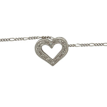 Load image into Gallery viewer, Bring delicate sparkle and heartfelt elegance to your jewellery collection with this pre-owned 9ct white gold diamond open heart pendant on an 18&quot; Figaro chain—a timeless piece with graceful charm and romantic detail.

Design: The 10mm by 12mm open heart pendant is adorned with sparkling diamonds along one side, creating a soft asymmetry that adds depth and brilliance.
Material: Made from 9-carat white gold, the polished finish provides a cool, refined backdrop that enhances the sparkle of the diamonds.

