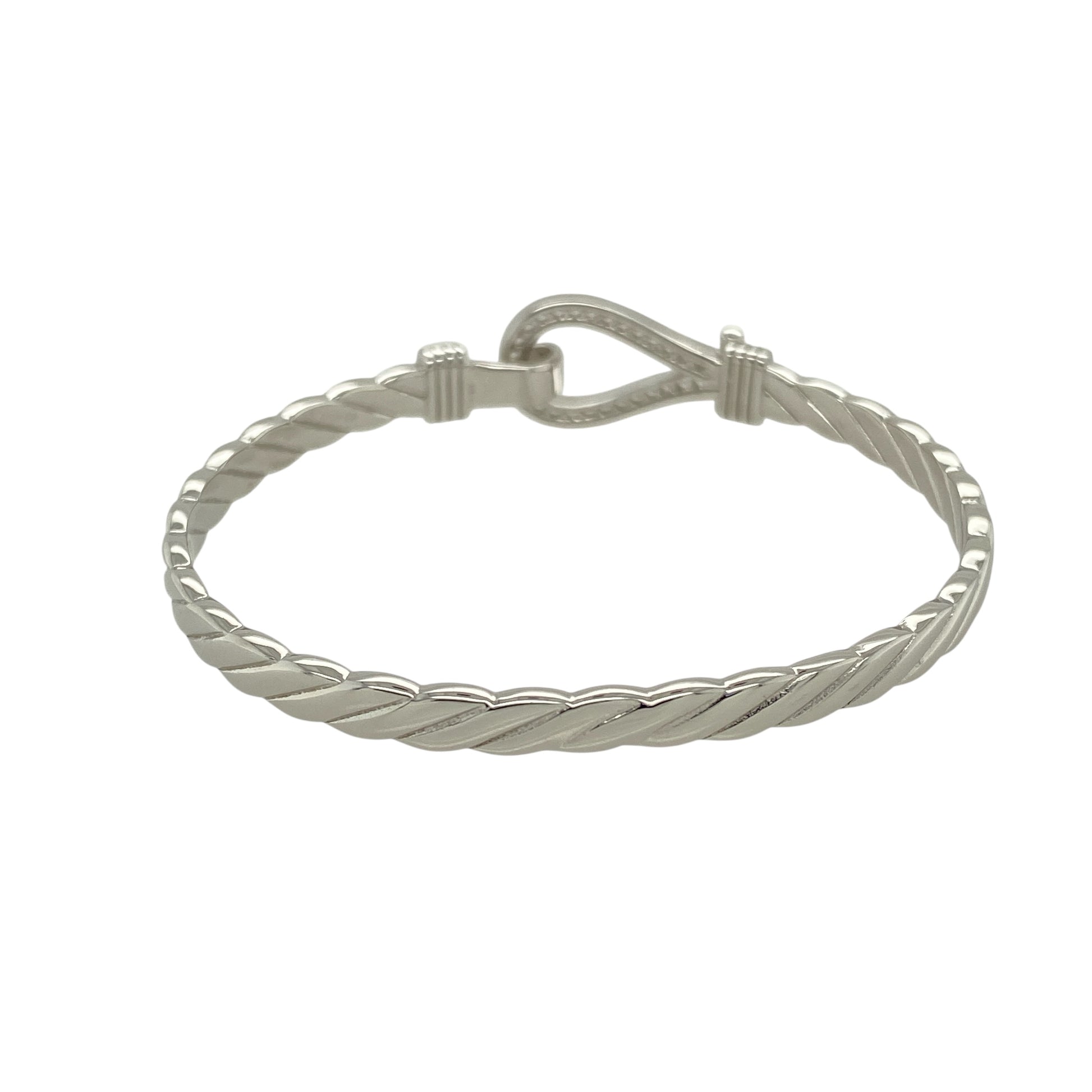 Bring playful sparkle and classic charm to a young jewellery collection with this new solid 925 silver and cubic zirconia children's horseshoe bangle—a sweet and symbolic piece designed with timeless appeal.

Design: The 11mm high front features a horseshoe motif adorned with shimmering cubic zirconia stones, symbolising luck and adding a touch of sparkle.
Material: Made from solid 925 sterling silver, the polished finish offers a bright, smooth shine that enhances the brilliance of the stones.
