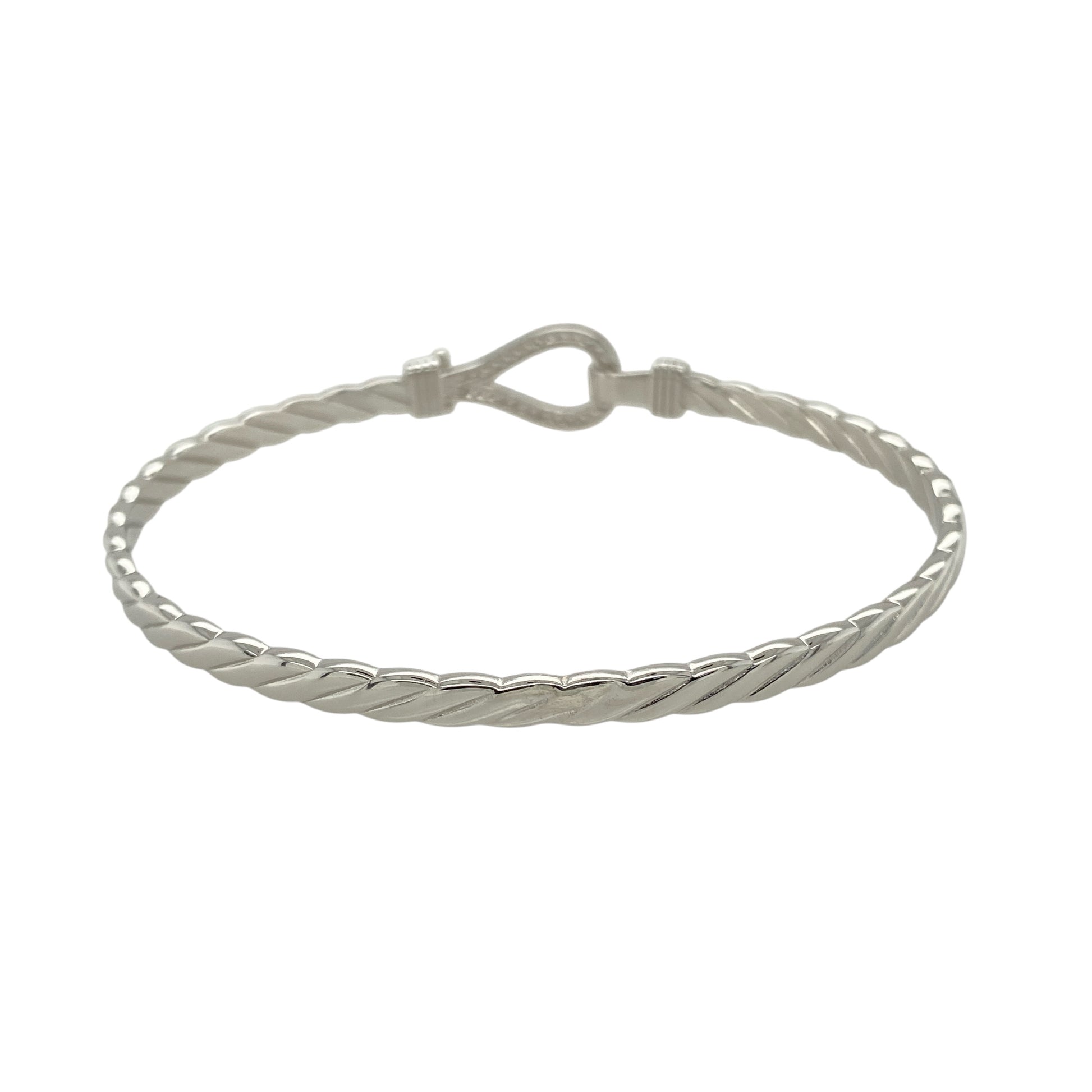 Bring bold shine and symbolic elegance to your jewellery collection with this new solid 925 silver and cubic zirconia horseshoe bangle—a timeless piece that blends luck, sparkle, and polished style.

Design: The 11mm high front features a classic horseshoe motif adorned with shimmering cubic zirconia stones, symbolising good fortune and adding eye-catching brilliance.
Material: Made from solid 925 sterling silver, the high-polish finish enhances the smooth shine and sparkle of the stones.
