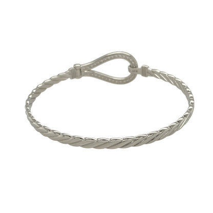 Bring classic symbolism and refined sparkle to your jewellery collection with this new solid 925 silver and cubic zirconia horseshoe bangle—a striking piece that combines timeless design with a touch of luck and brilliance.

Design: The 17mm high front features a bold horseshoe motif set with cubic zirconia stones, offering a radiant symbol of good fortune and graceful style.
