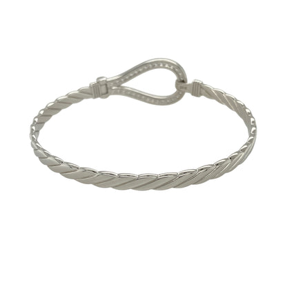Bring bold brilliance and timeless symbolism to your jewellery collection with this new solid 925 silver and cubic zirconia horseshoe bangle—a statement piece that combines strength, style, and a touch of luck.

Design: The 20mm high front features a prominent horseshoe motif encrusted with sparkling cubic zirconia stones, creating a radiant symbol of good fortune and standout elegance.
