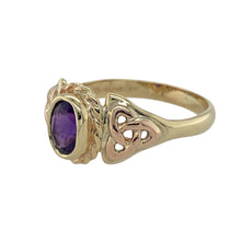 Load image into Gallery viewer, Bring heritage style and rich colour to your collection with this pre-owned 9ct yellow and rose Welsh gold Celtic ring set with amethyst—a meaningful design with timeless elegance.

Design: This striking ring features a 7mm by 5mm oval-cut amethyst at its centre, framed by traditional Celtic knotwork that adds depth and symbolism.
Material: Made from a blend of 9-carat yellow and rare rose Welsh gold, the dual tones enhance the regal purple of the amethyst with warm contrast.

