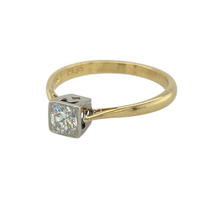 Bring refined brilliance and timeless elegance to your collection with this pre-owned 18ct yellow gold and platinum diamond solitaire ring—a classic design with a contemporary touch.

Design: This ring features a 0.25ct brilliant-cut diamond set in a square platinum setting, offering clean lines and modern sophistication.
Material: Made from 18-carat yellow gold with a platinum setting, the contrast of metals enhances the brightness of the diamond and adds a luxurious finish.
